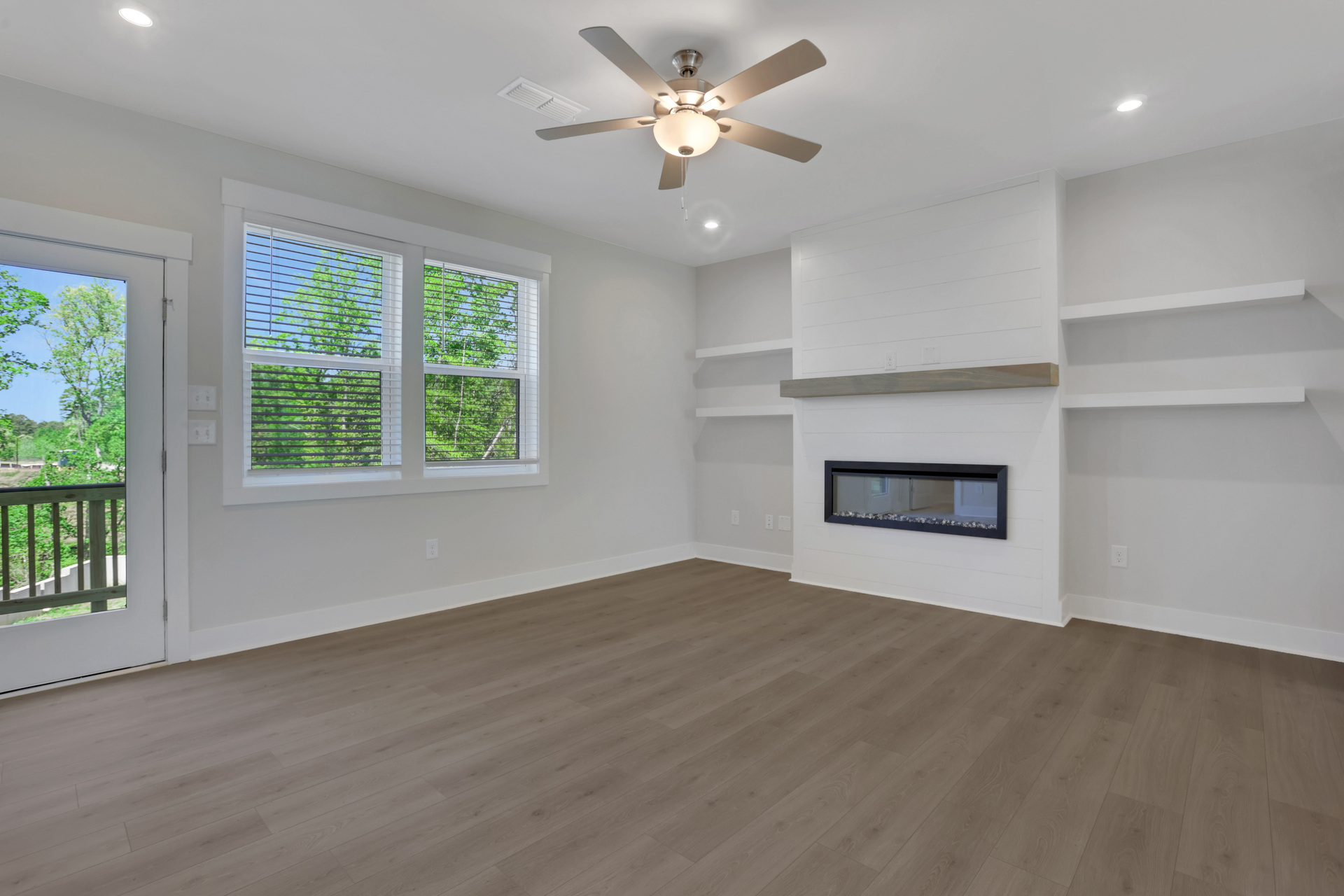 great room with electric fireplace and hard-surface flooring