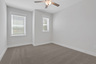 secondary bedroom with carpet and windows
