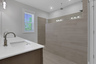 primary bath with oversized walk-in shower and tile floors