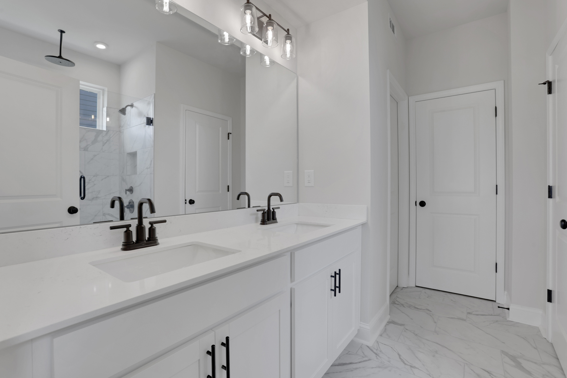 primary bathroom with white cabinets and tile flooring 
