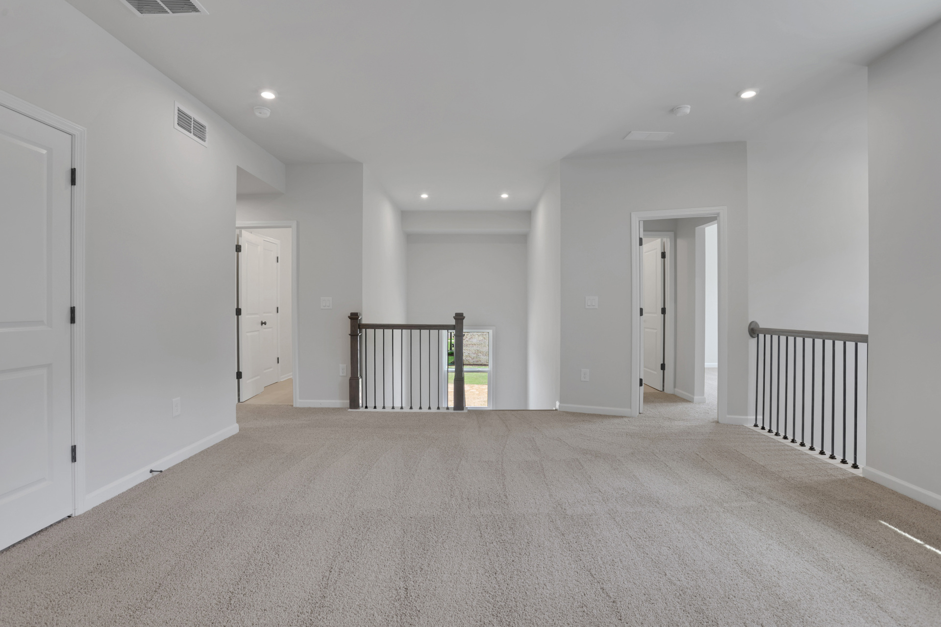 loft with carpet and white paint on the walls 
