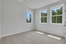 bedroom with windows and carpet