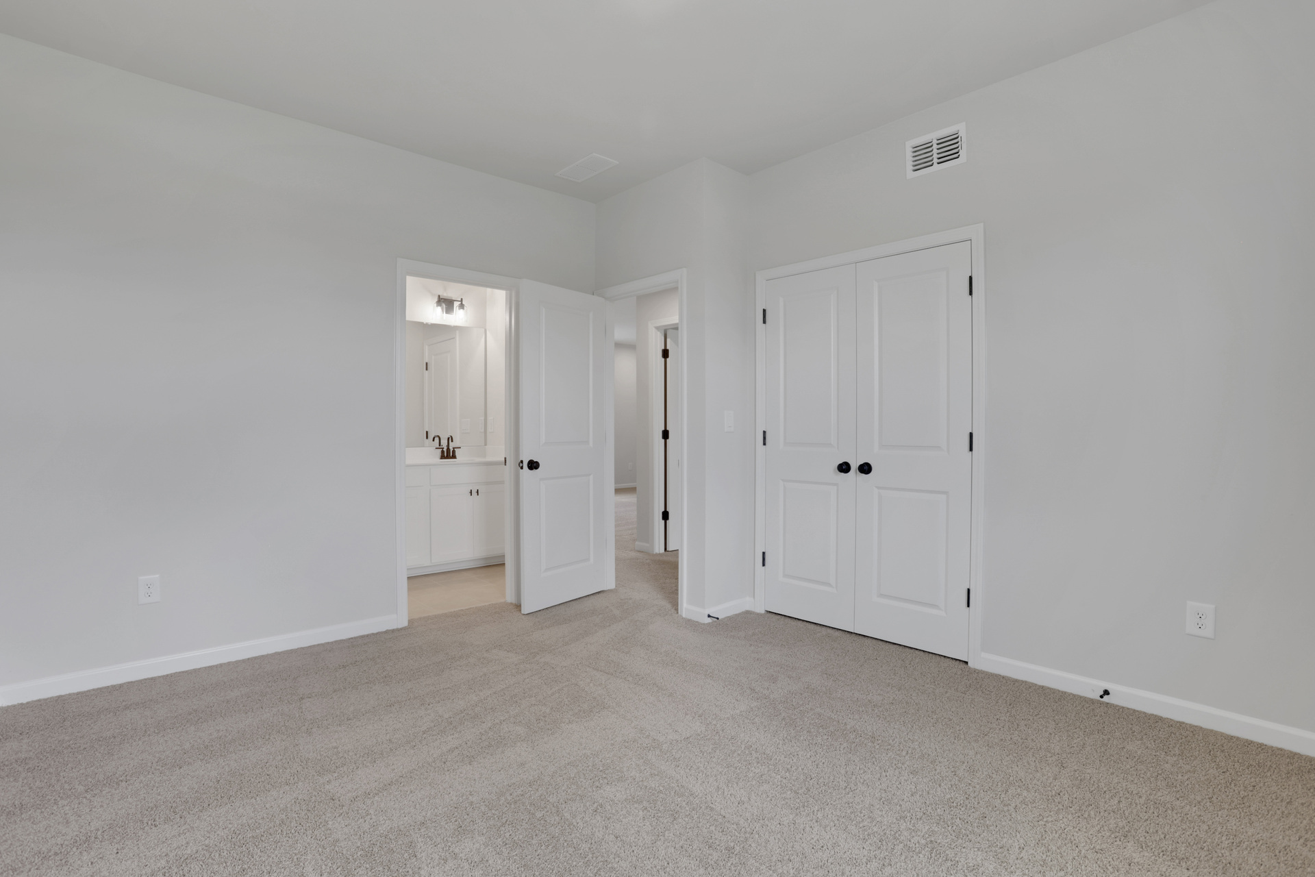 secondary bath with dual vanity and white cabinets