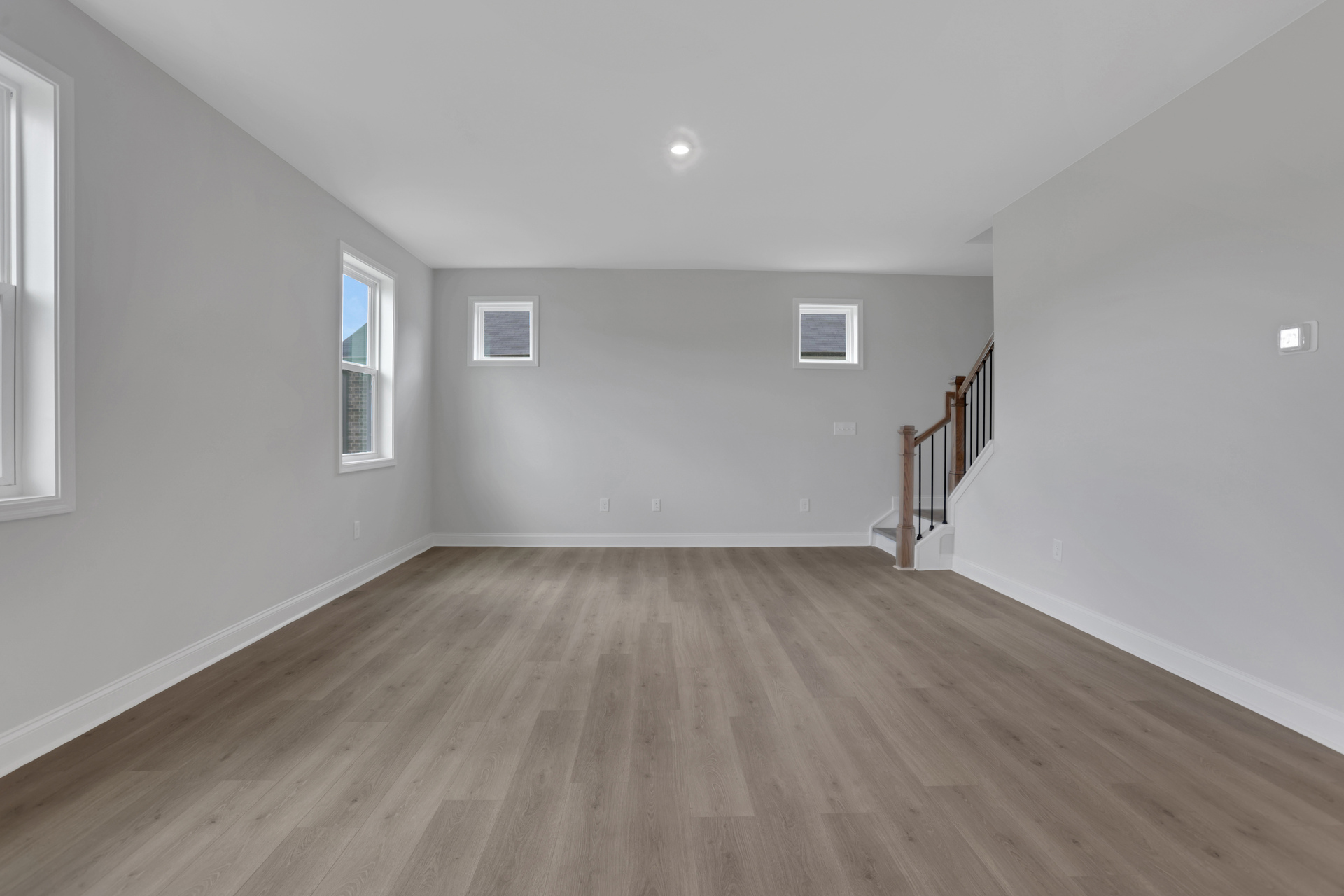 great room with hard-surface floors and windows