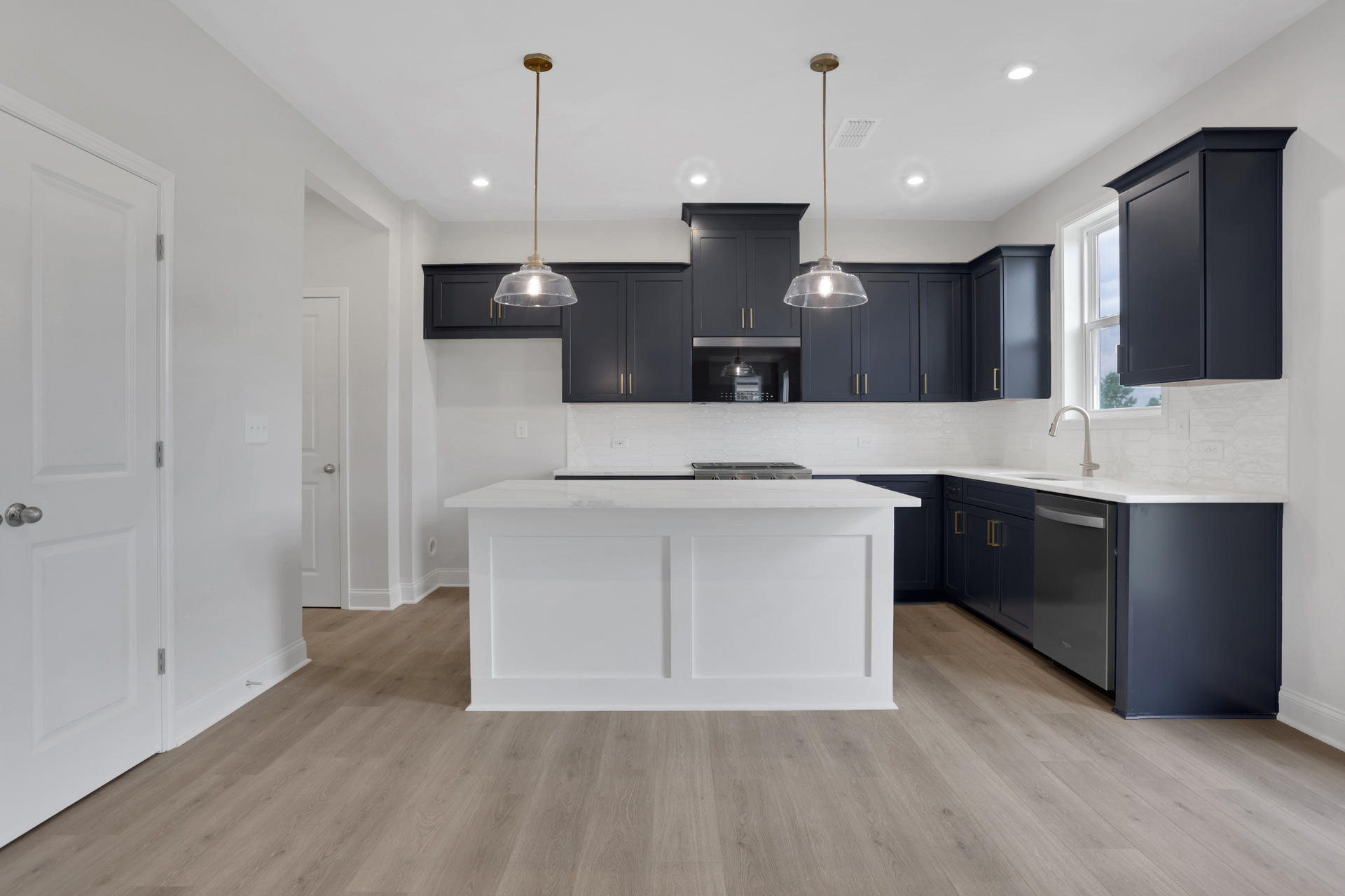 kitchen with navy cabinets and white quartz counters