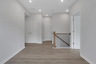 loft with hard-surface flooring and white paint on the walls