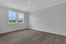 primary bedroom with hard-surface flooring and windows