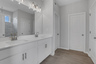 primary bathroom witth white cabinets and dual vanity