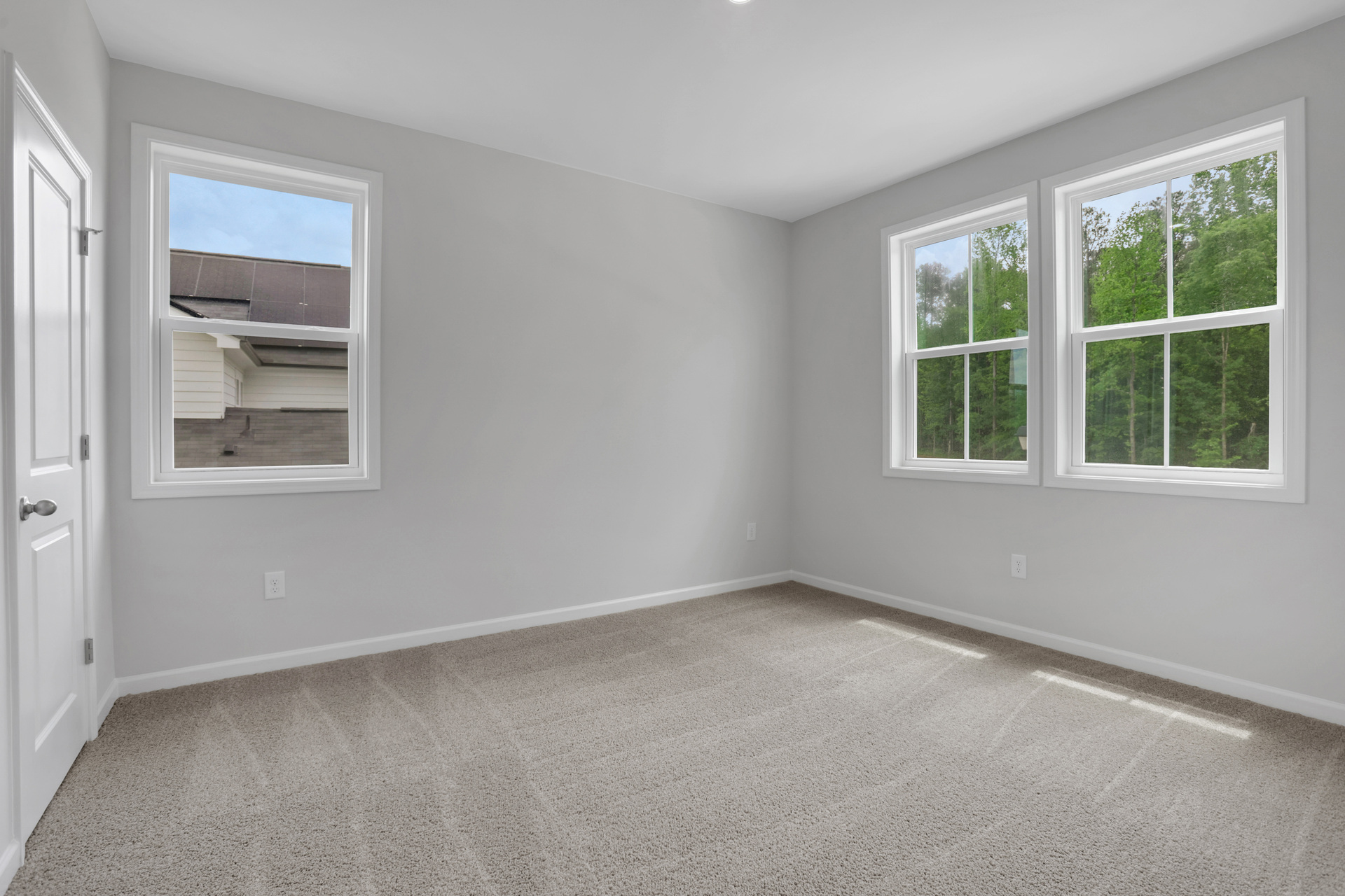 secondary bedroom with carpet and windows