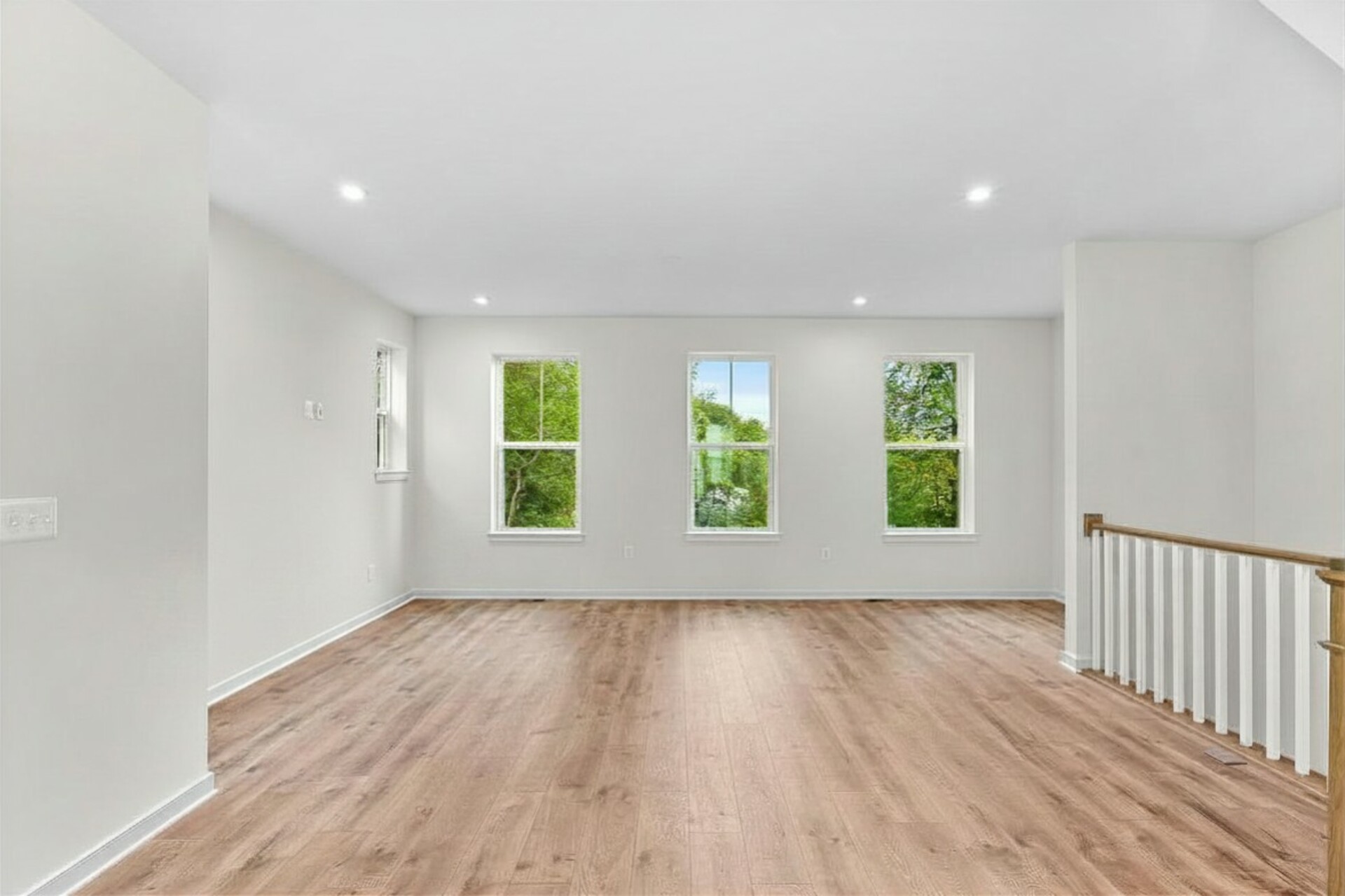 hardwood floors for living room and three windows