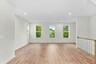hardwood floors for living room and three windows