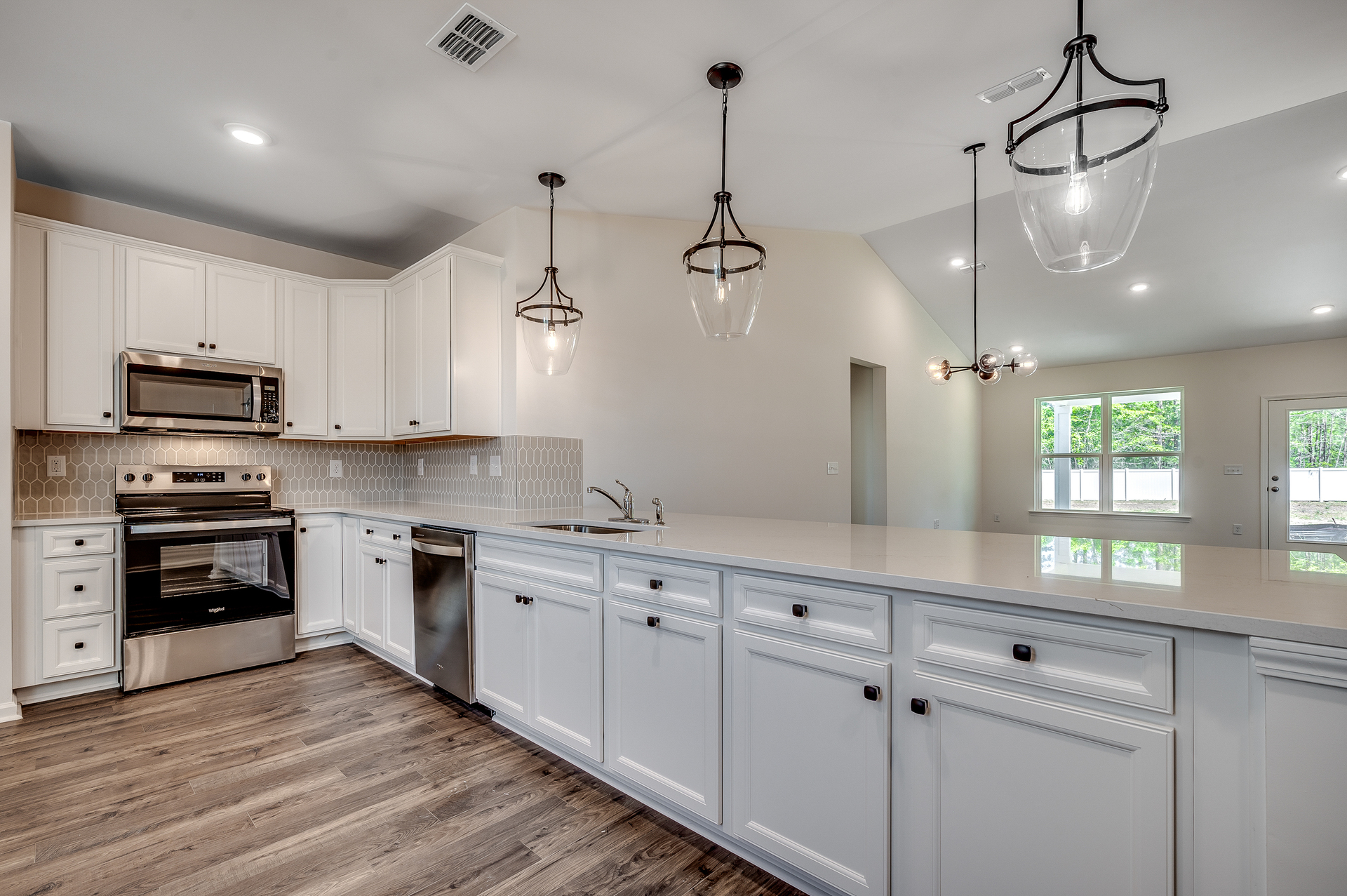 spacious island with bright white cabinets and countertops 