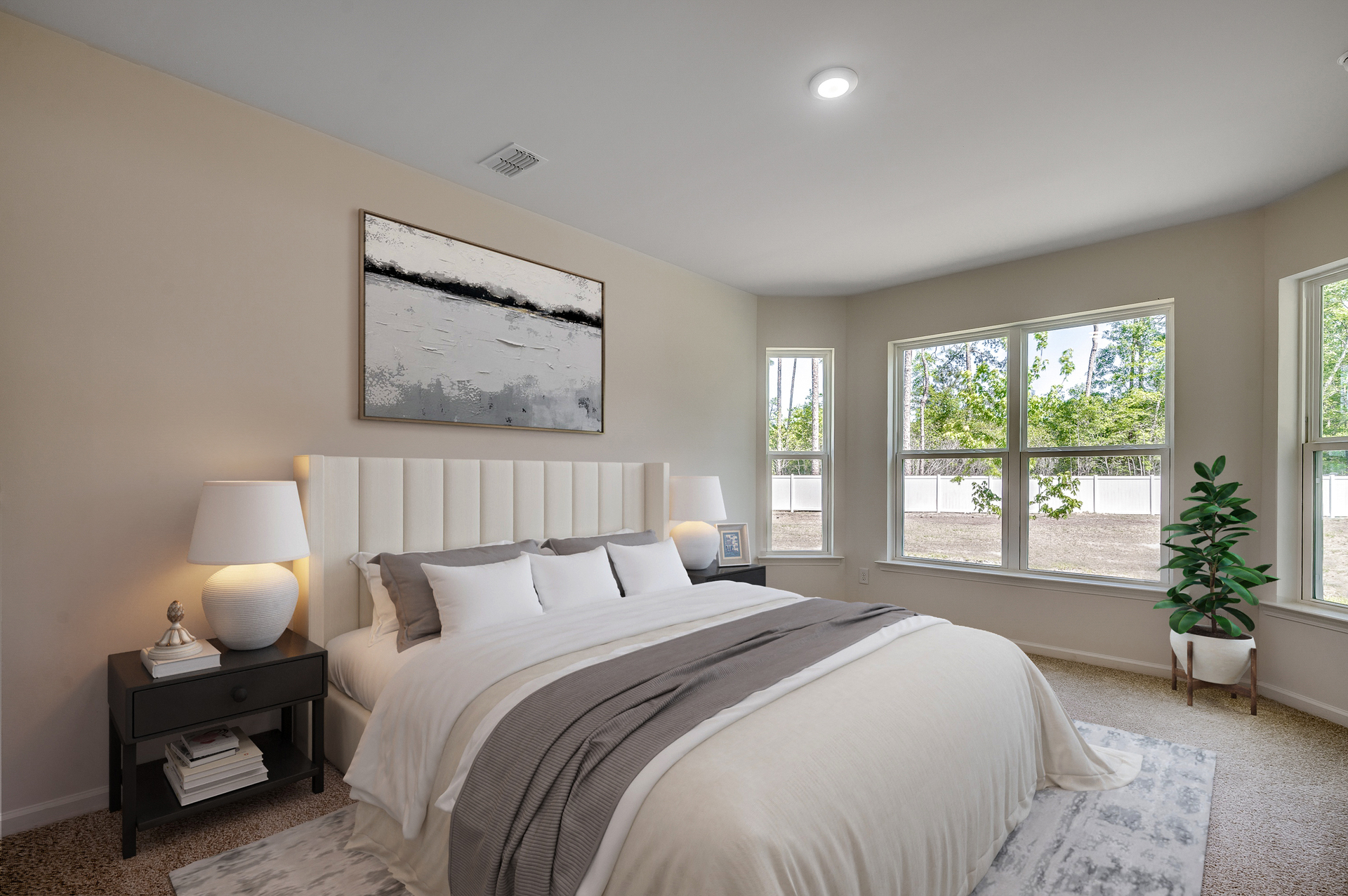 spacious room with large windows for natural lighting and carpeting throughout 