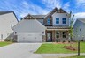 front of 2-story home with light siding and dark brick