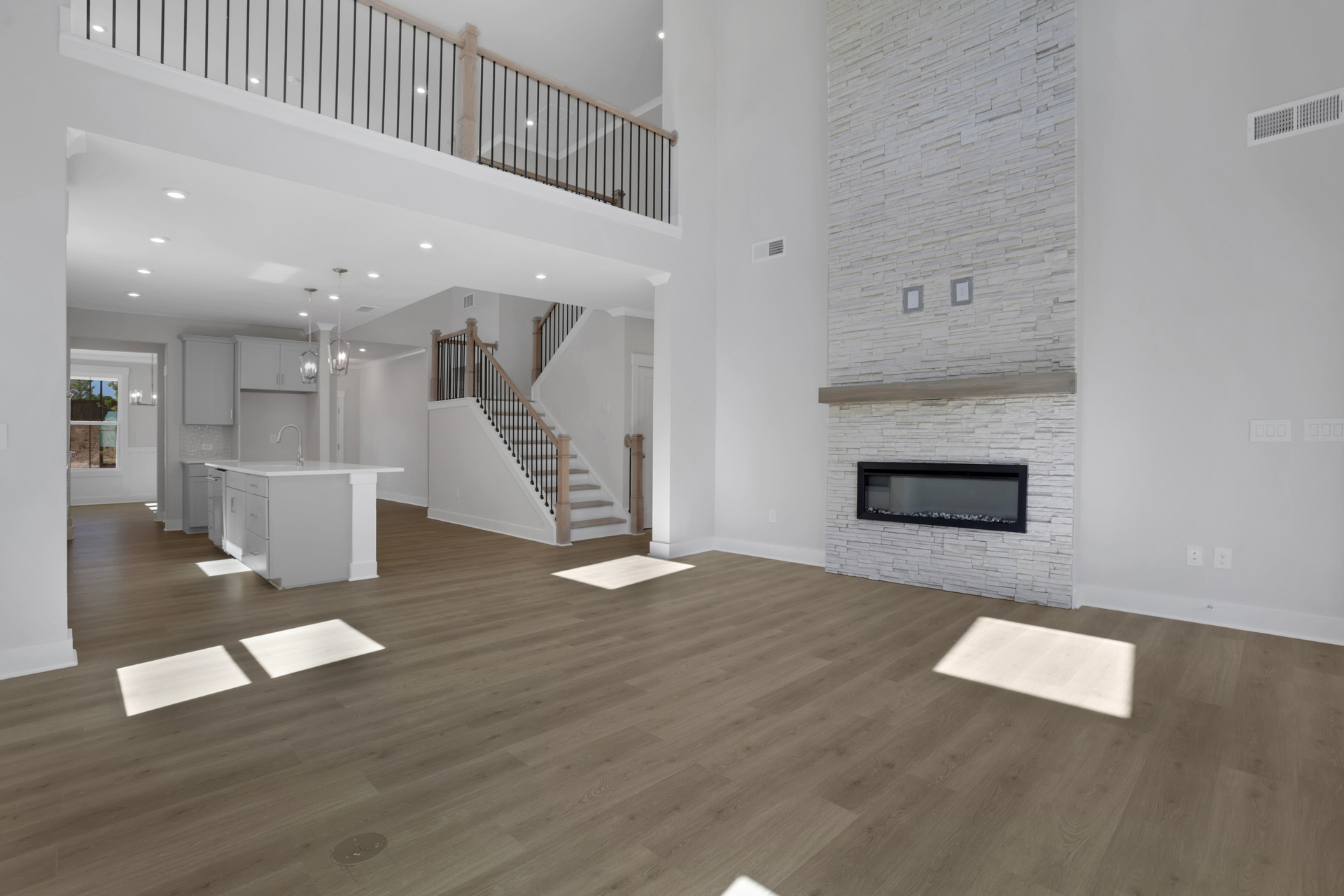 2-story great room with hard-surface flooring and 2-story fireplace