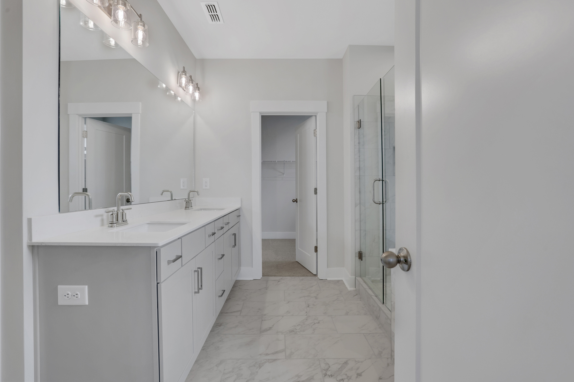 primary bathroom with gray cabinets and tile flooring