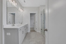 primary bathroom with gray cabinets and tile flooring