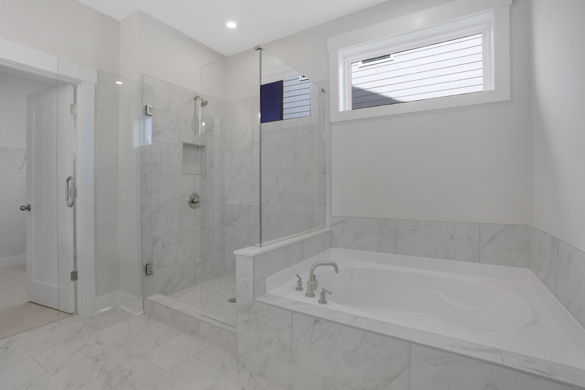 primary bathroom with separate walk-in shower and tub