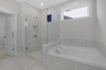 primary bathroom with separate walk-in shower and tub
