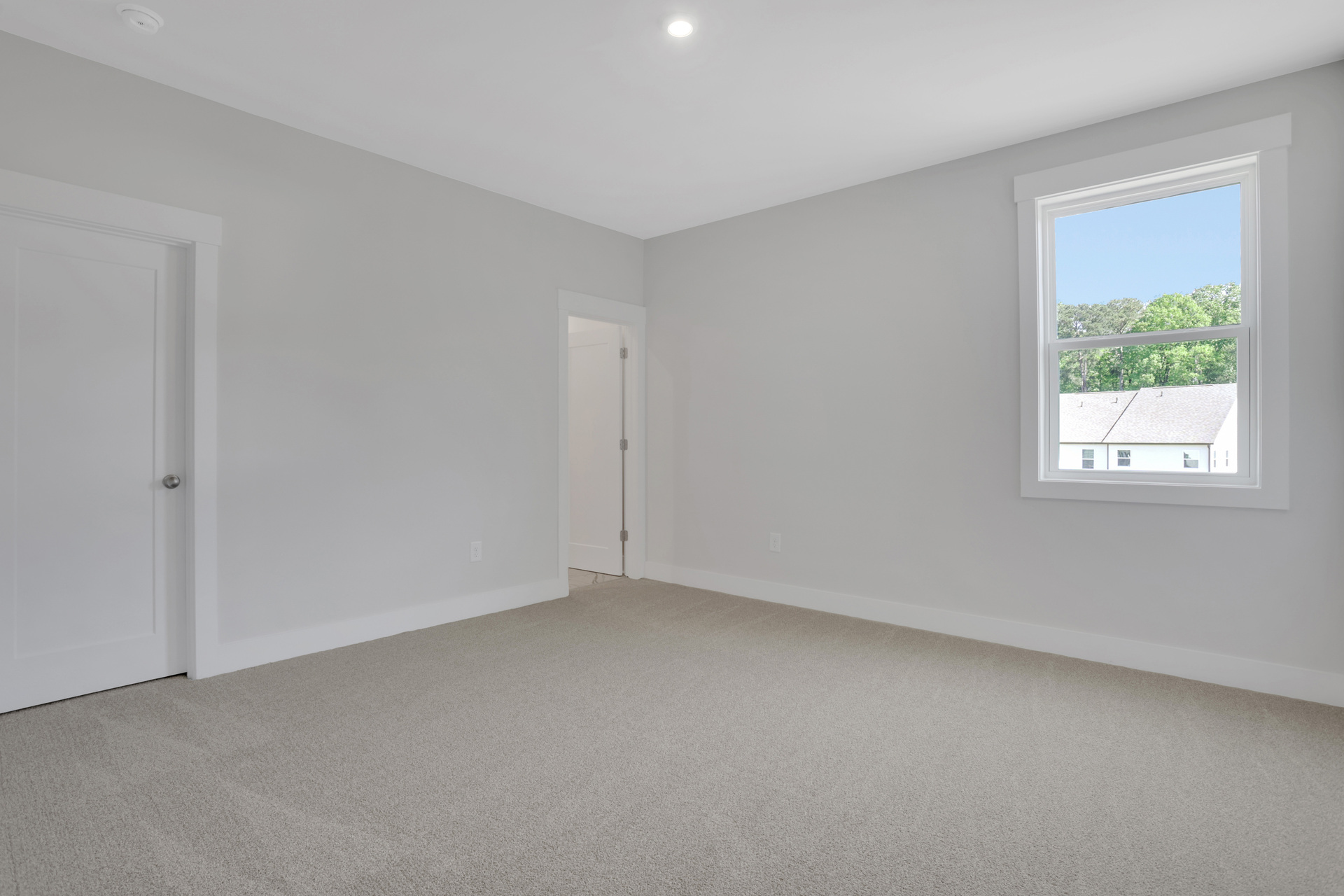 secondary bedroom with carpet and windows