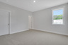 secondary bedroom with carpet and windows