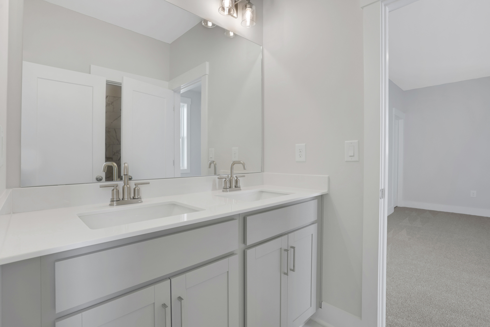 jack and jill secondary bathroom with gray cabinets and white quartz counters
