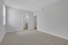 secondary bedroom with carpet and windows