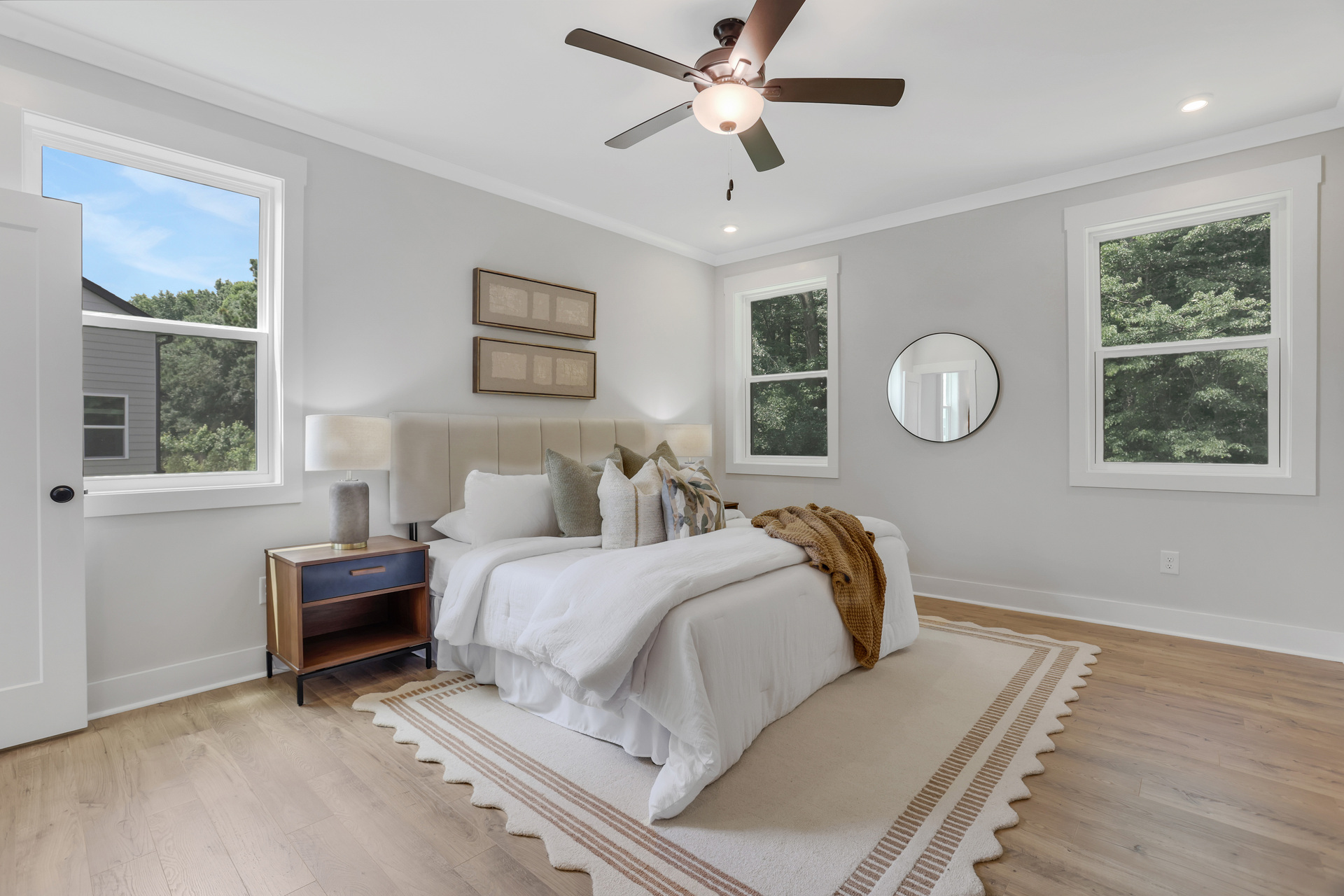 primary bedroom with windows and hard surface floors