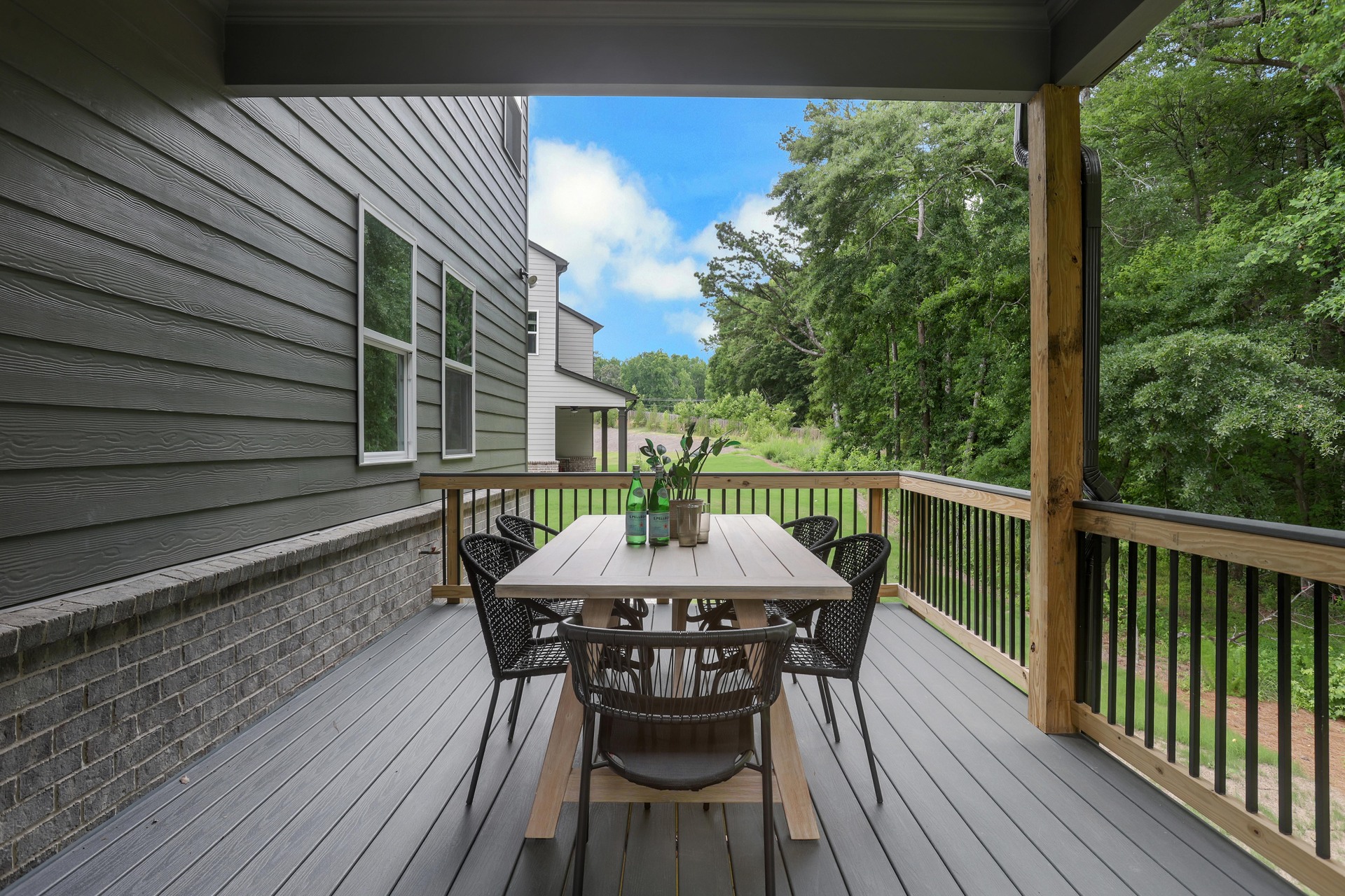 covered back deck overlooking backyard with furniture