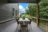 covered back deck overlooking backyard with furniture