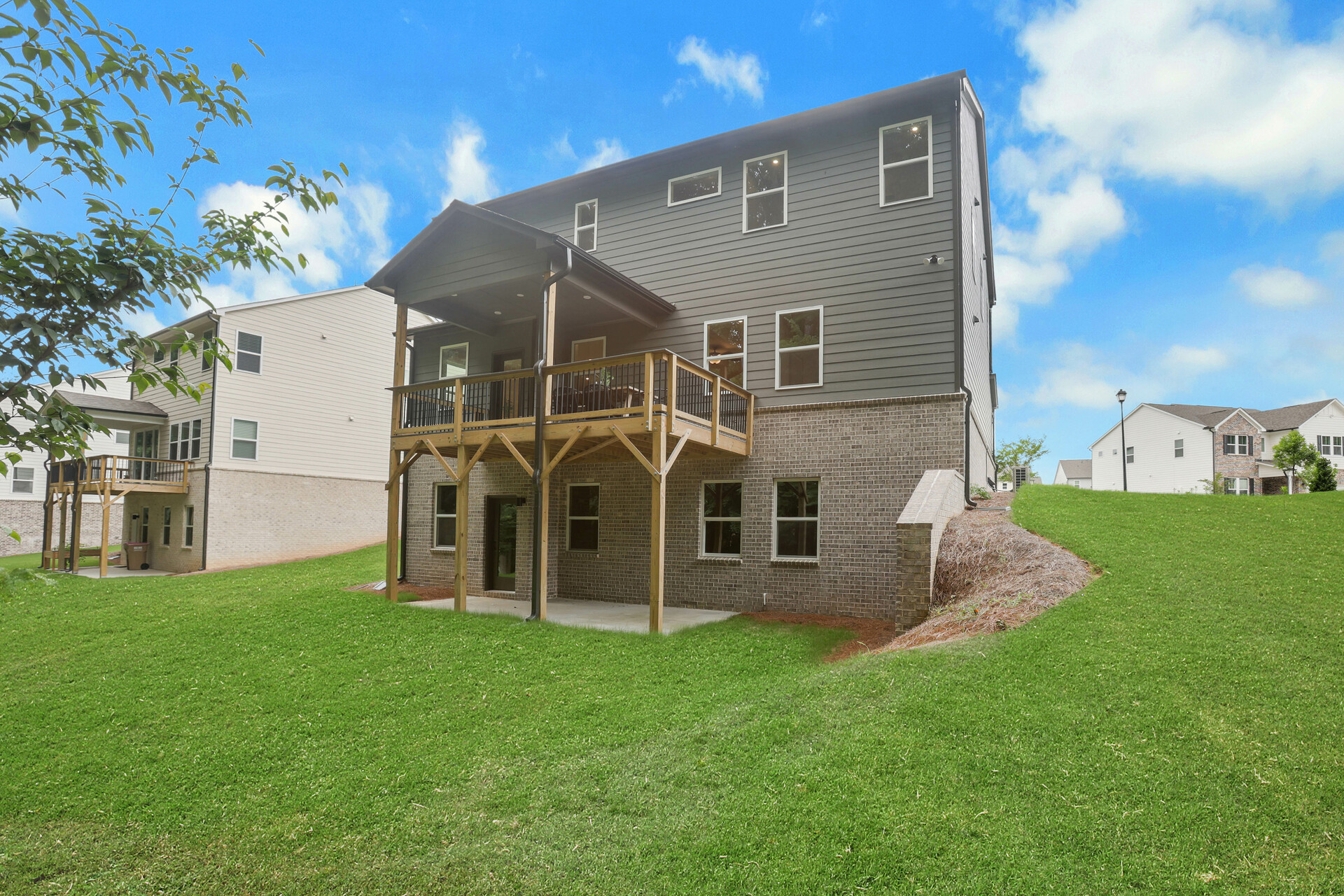 back of 2-story home on a basement with covered deck
