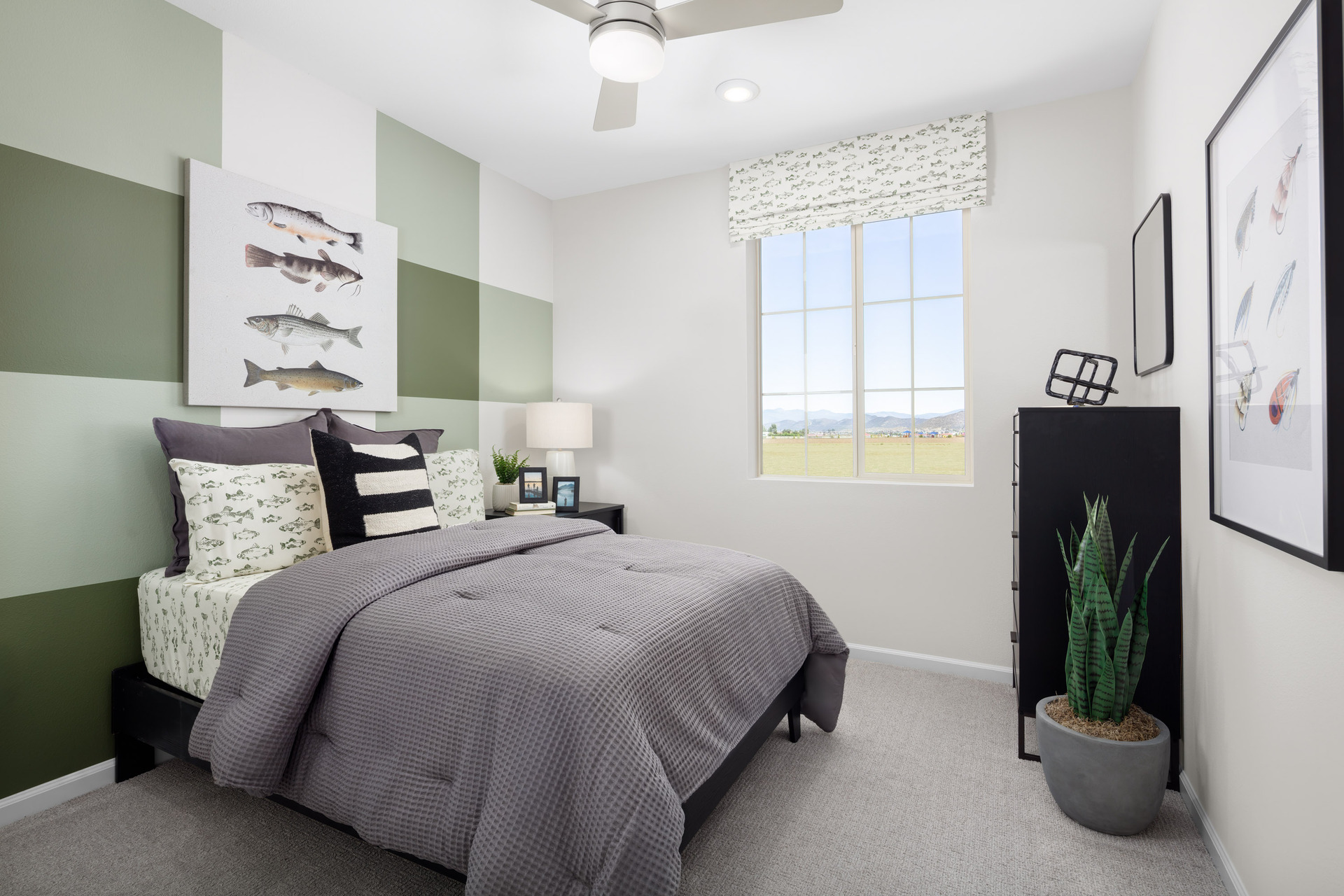bedroom with a bed that has a grey comforter and a green checkered wall