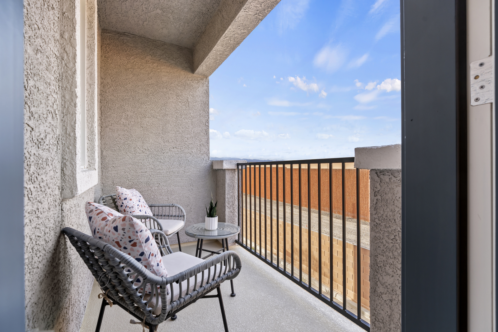 balcony with two chairs and blue sky