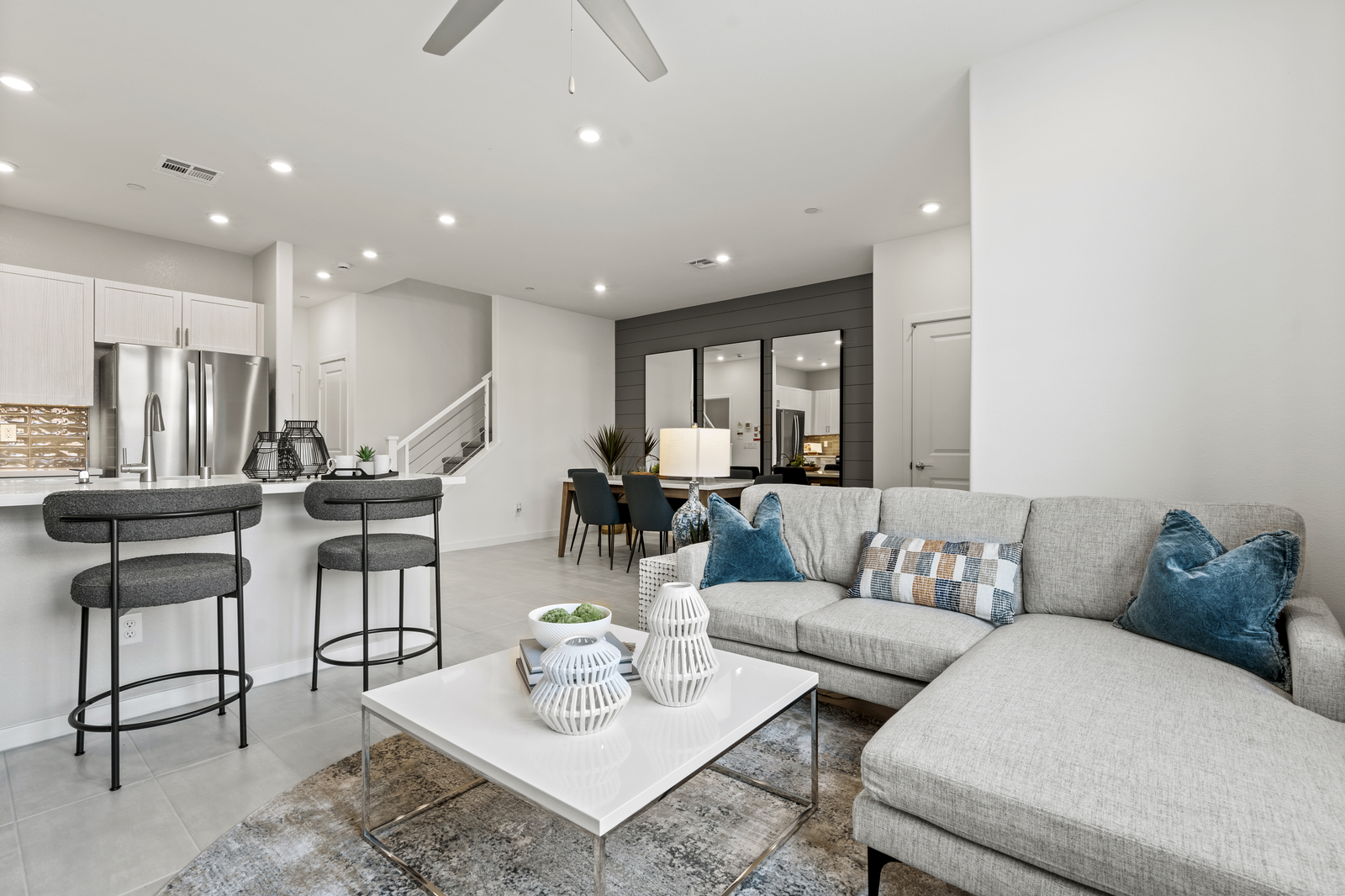great room with couch, dining table, and rugs
