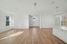 great room with large windows and wood flooring