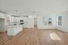 kitchen with island, white counters, white cabinets, and stainless steel appliances