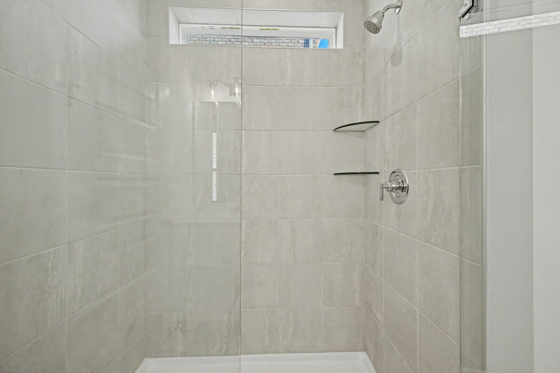 primary bathroom with walk in shower and dual sink vanity