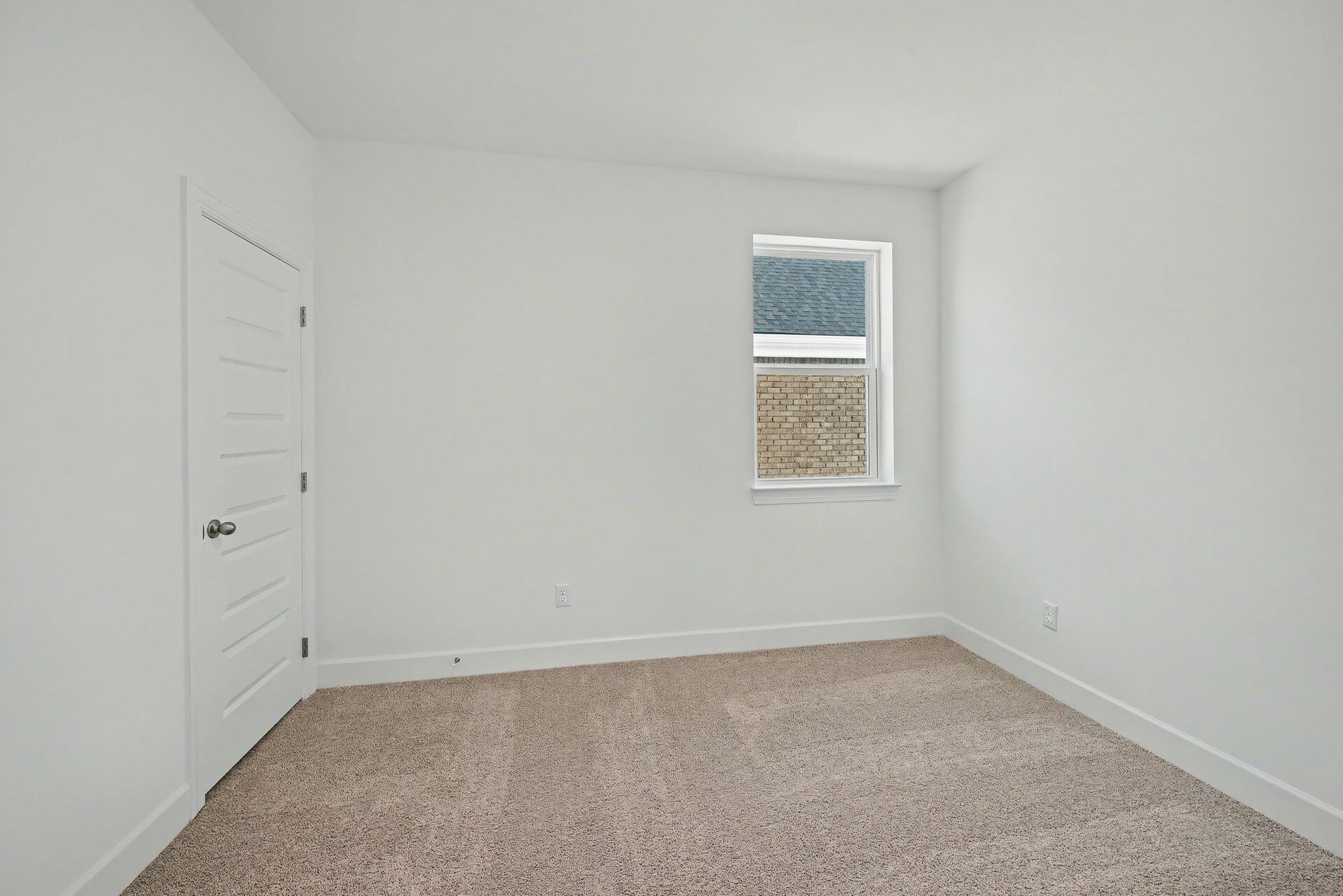 bedroom with carpet, large windows, and walk in closets