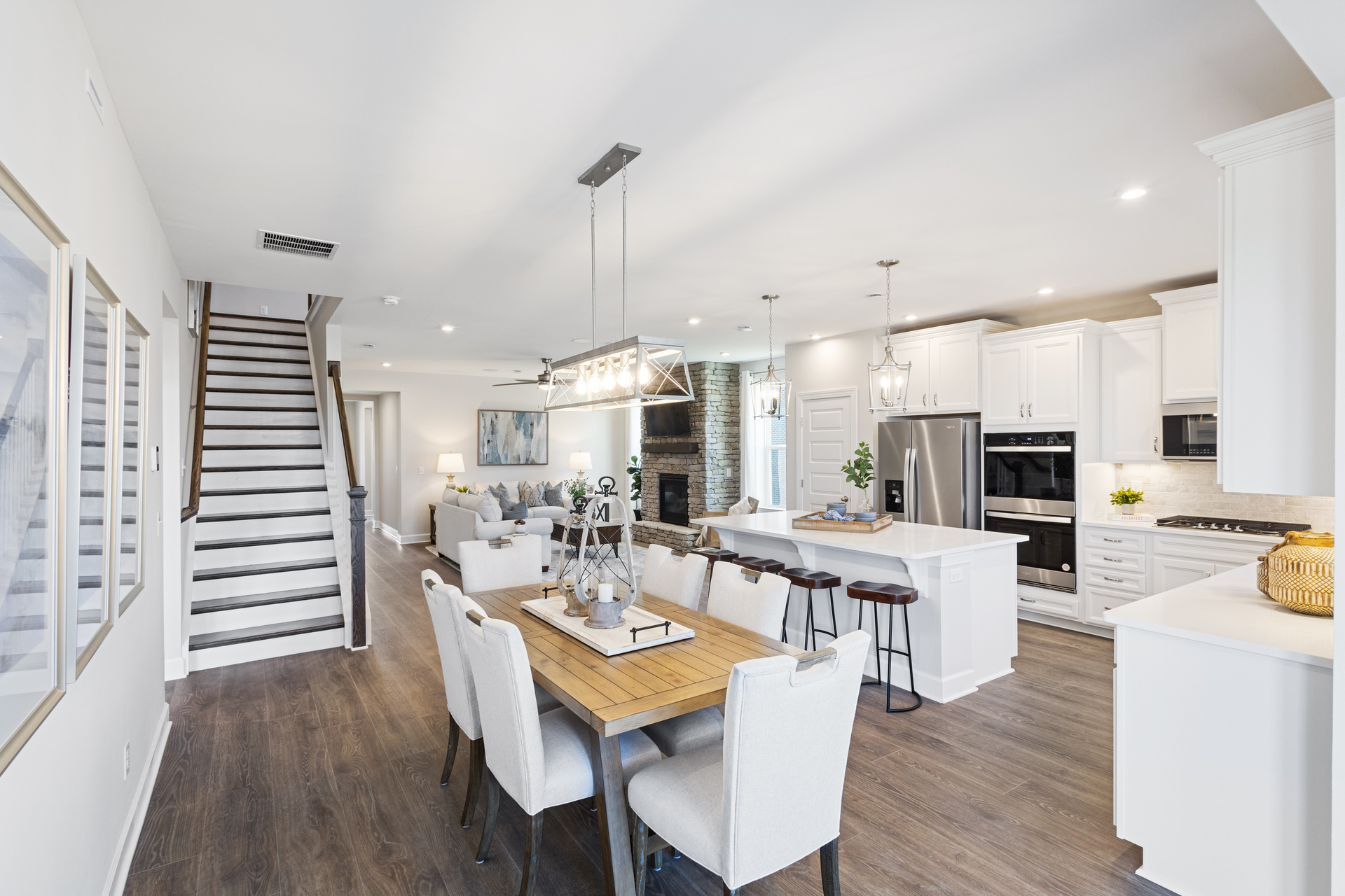 dining room with open concept to kitchen and great room, with wood floors