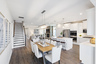 dining room with open concept to kitchen and great room, with wood floors