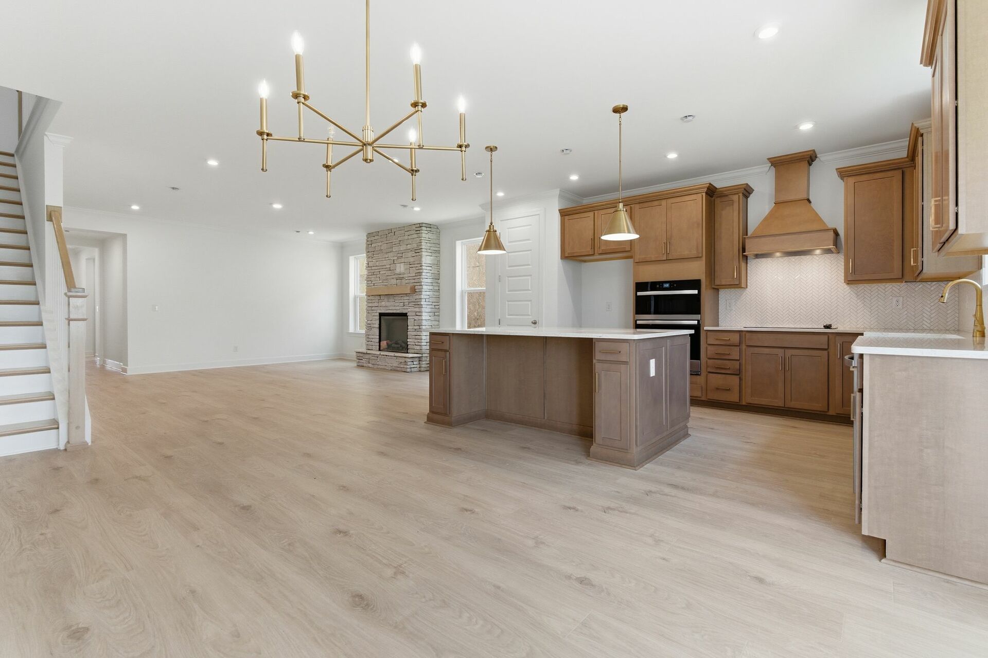 kitchen with wood cabinets, a large island, and gold pendant lighting