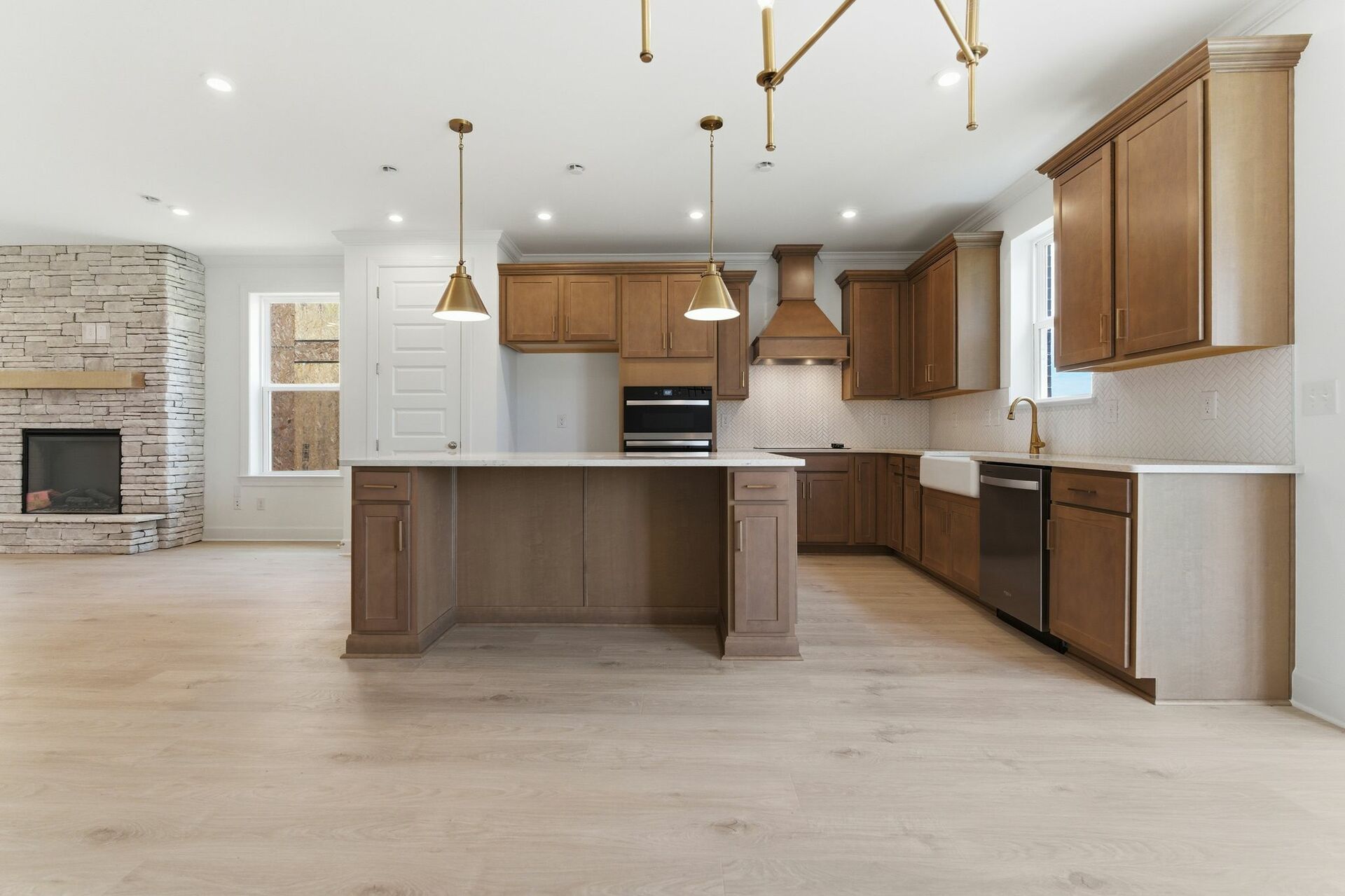 kitchen with wood cabinets, a large island, and gold pendant lighting