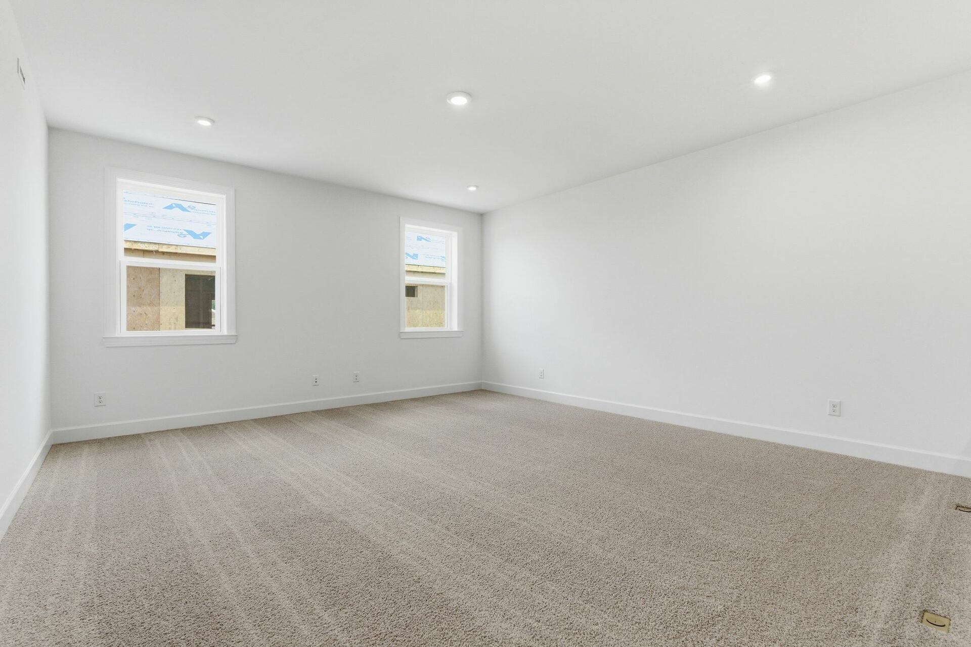 upstairs loft with carpet and large windows