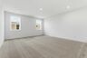 upstairs loft with carpet and large windows