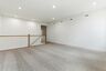 upstairs loft with carpet and large windows