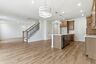 kitchen with wood cabinets, built in microwave and oven, island with sink, and stainless-steel appliances