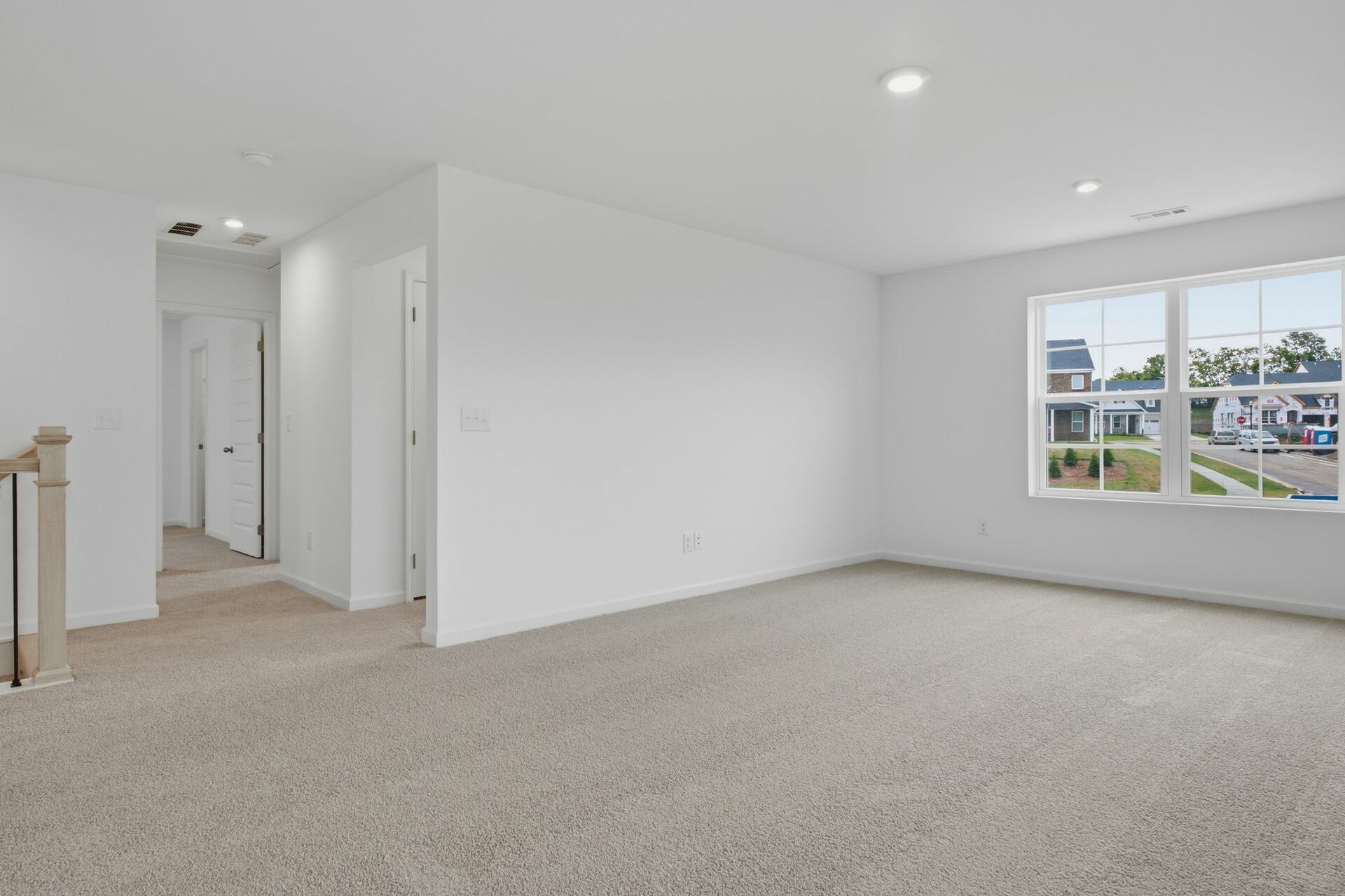 bonus room with oversized windows and carpet