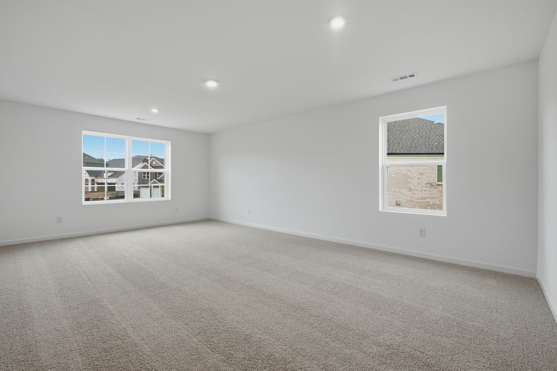 bonus room with oversized windows and carpet