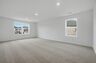 bonus room with oversized windows and carpet