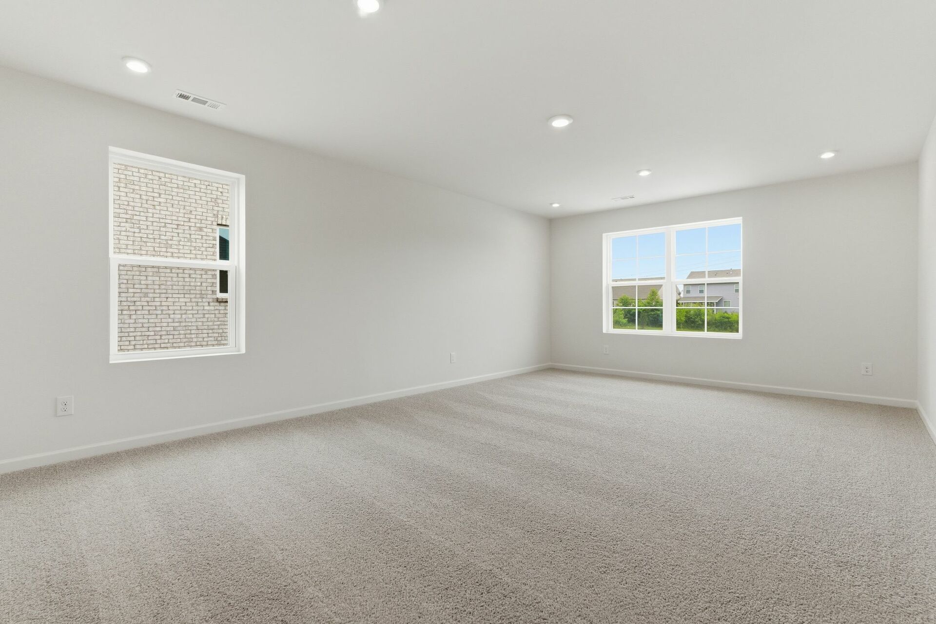Bonus room with carpet and large windows
